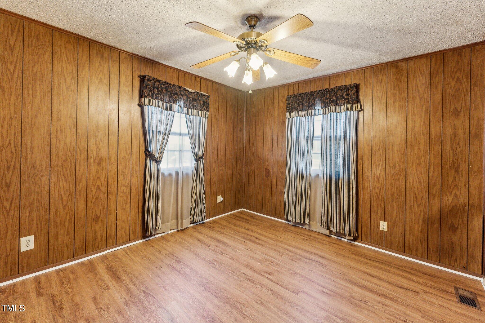 3115 Legion Road Hope Mills, NC 28348 - Photo 13 of 26 wooden floor in an empty room with a window