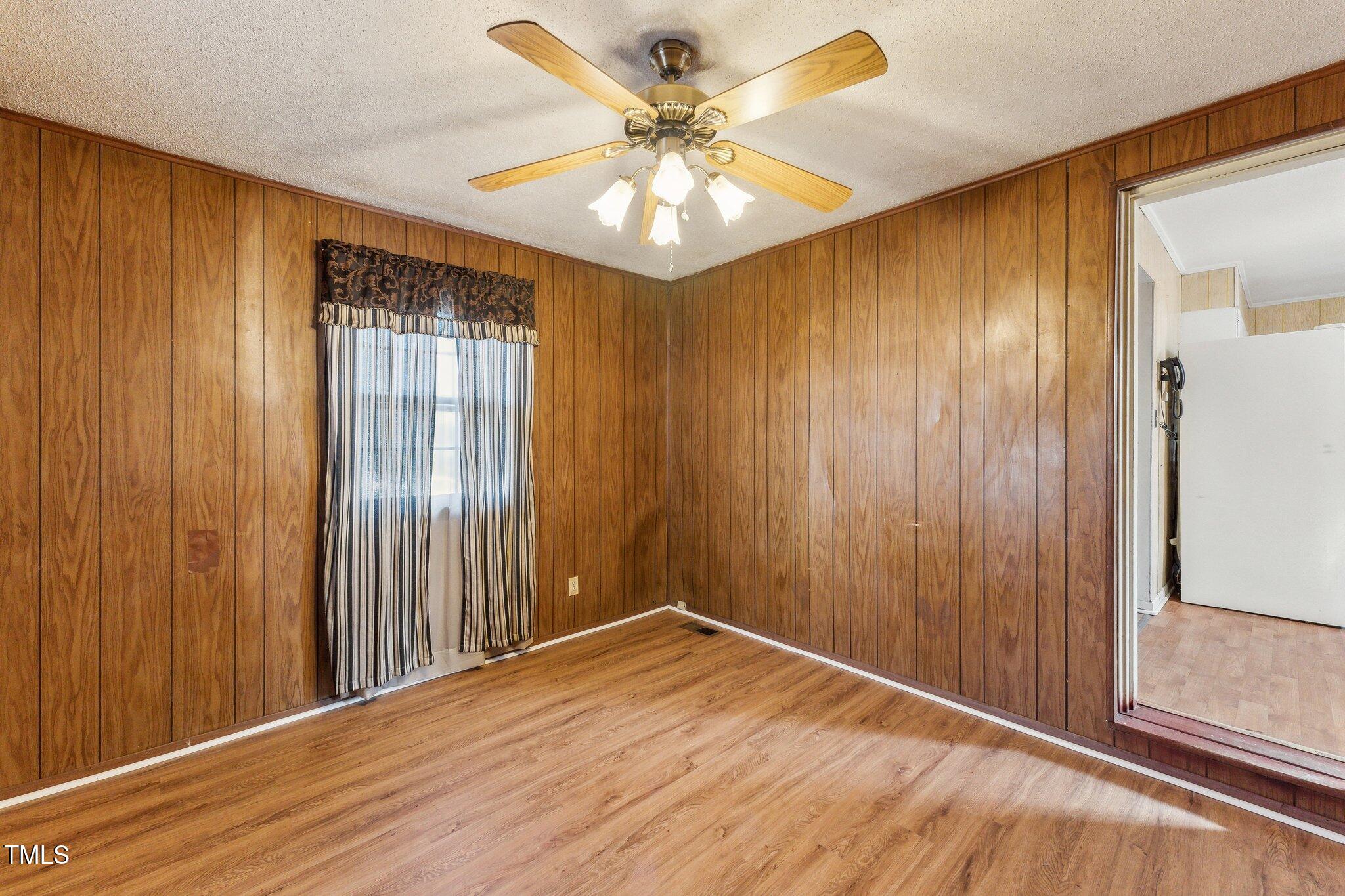 3115 Legion Road Hope Mills, NC 28348 - Photo 14 of 26 wooden floor in an empty room with a window