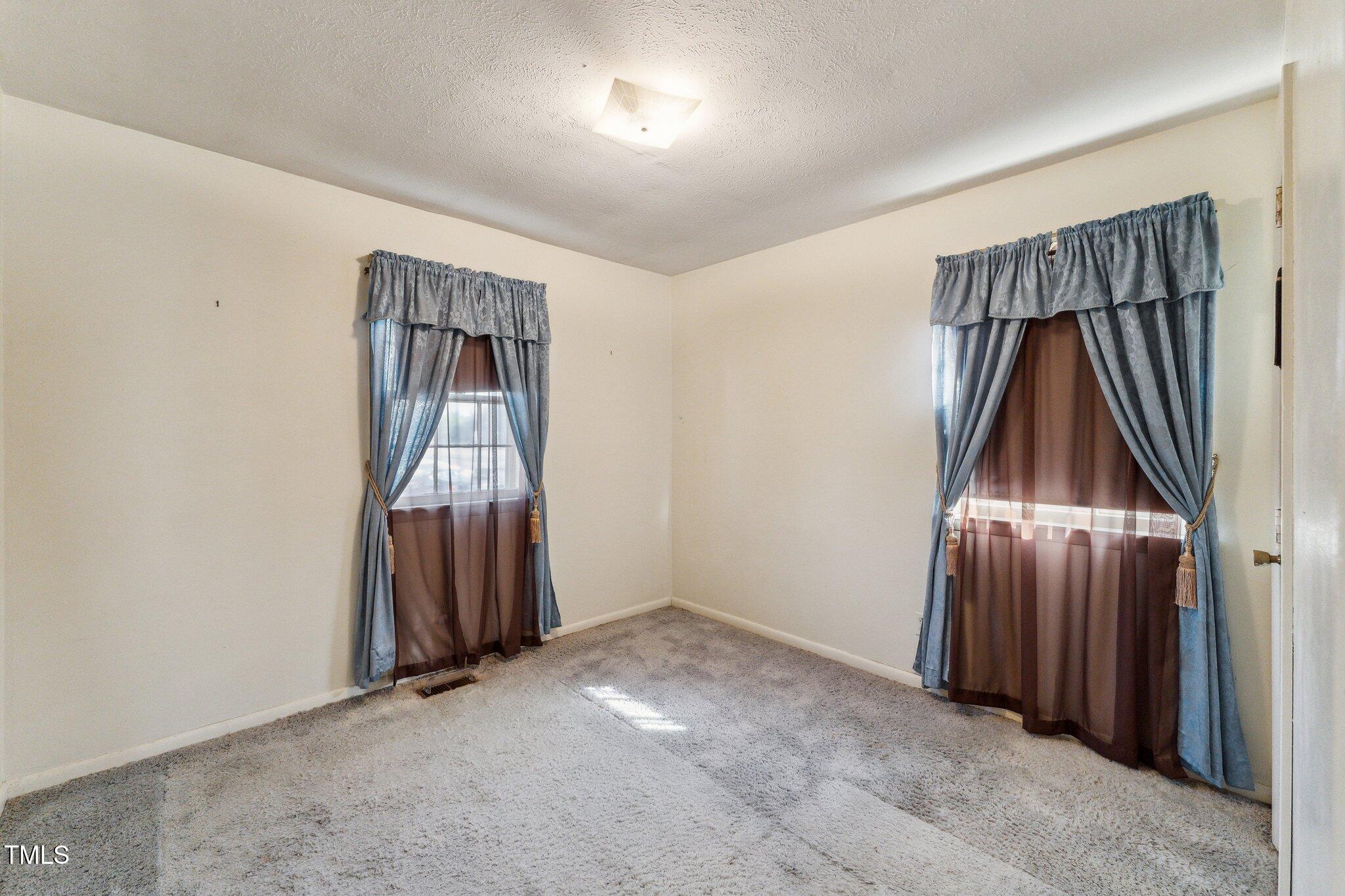 3115 Legion Road Hope Mills, NC 28348 - Photo 16 of 26 an empty room with a hallway and a mirror