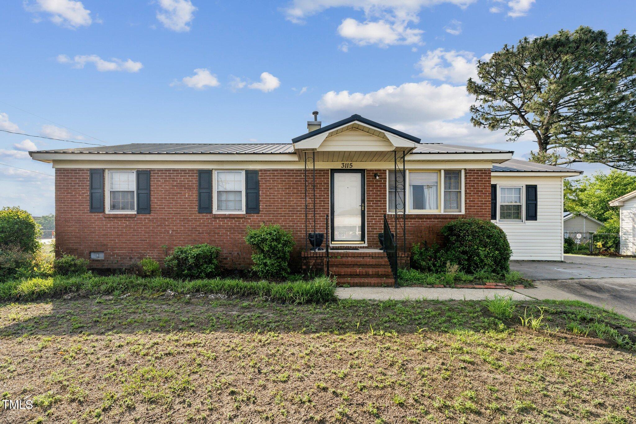 3115 Legion Road Hope Mills, NC 28348 - Photo 2 of 26 a front view of a house with garden