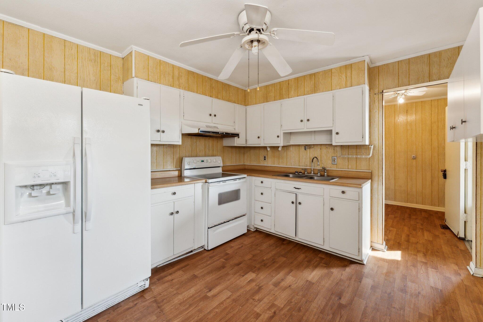 3115 Legion Road Hope Mills, NC 28348 - Photo 6 of 26 a kitchen with stainless steel appliances white cabinets and a refrigerator
