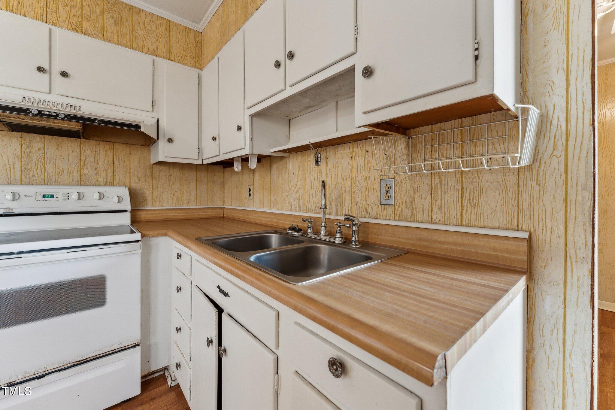 3115 Legion Road Hope Mills, NC 28348 - Photo 8 of 26 a kitchen with a sink cabinets and window