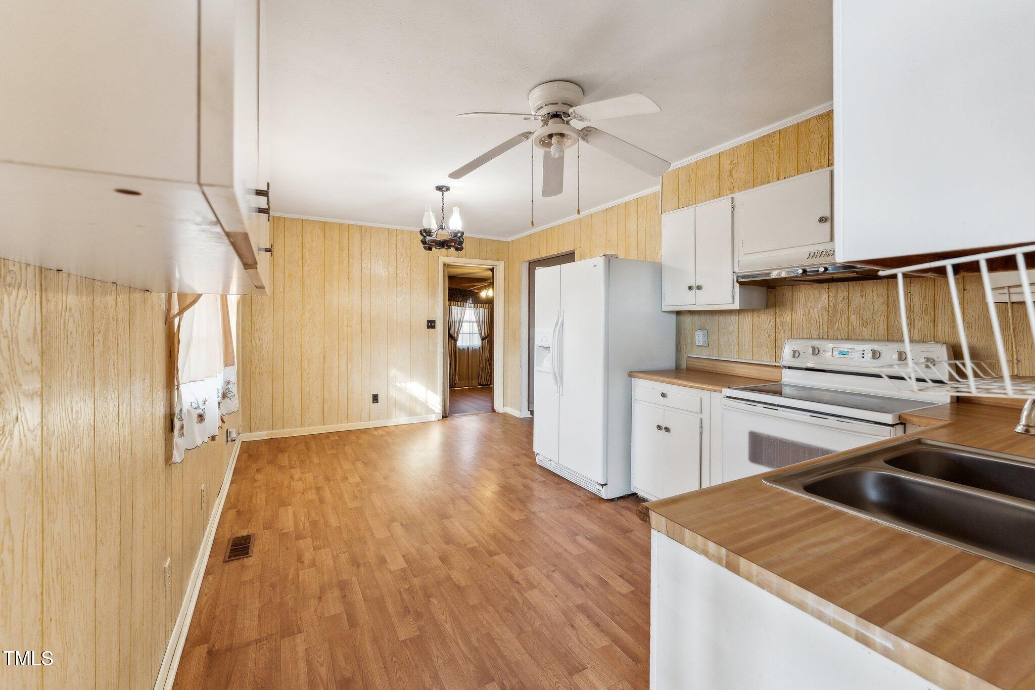 3115 Legion Road Hope Mills, NC 28348 - Photo 10 of 26 a kitchen with a refrigerator a sink and cabinets