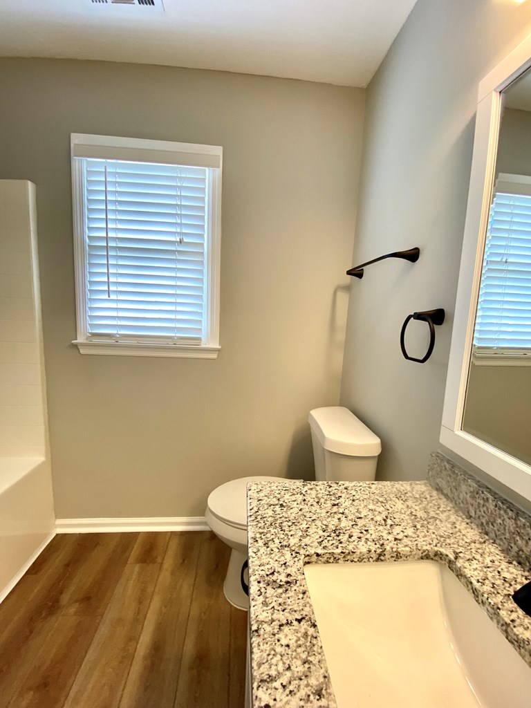 6032 North Pointe Drive Columbus, GA 31909 - Photo 15 of 26 a bedroom with a bed and wooden floor