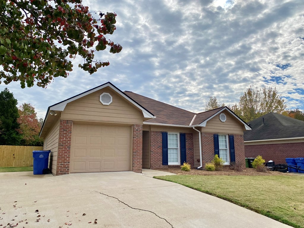 6032 North Pointe Drive Columbus, GA 31909 - Photo 2 of 26 a front view of a house with a yard and garage