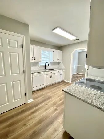 a kitchen with stainless steel appliances granite countertop a sink stove and cabinets