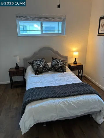 a bedroom with a bed and window