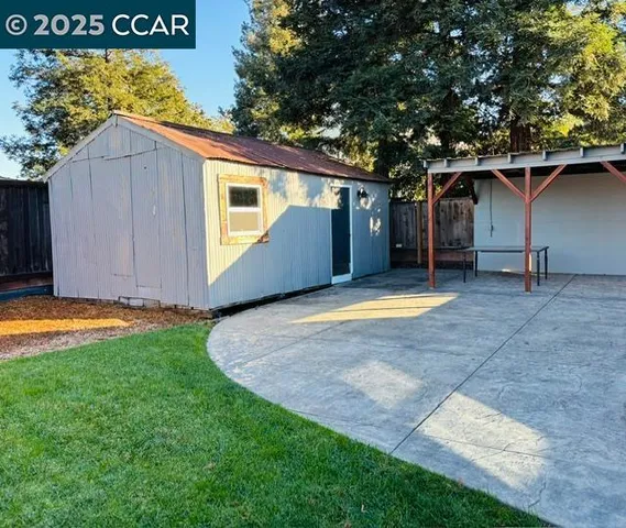 a view of backyard with a sink and wooden fence