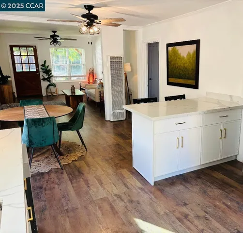 a living room with furniture a flat screen tv and a wooden floor