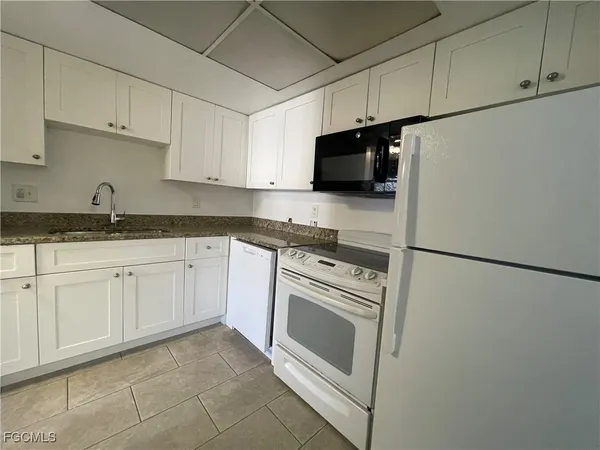 a kitchen with stainless steel appliances a refrigerator sink and cabinets