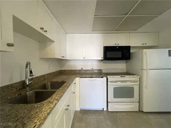a kitchen with a sink stove and refrigerator