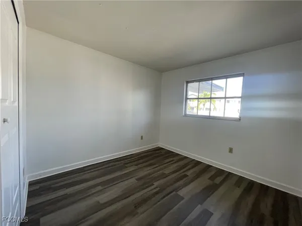a room with wooden floor and window