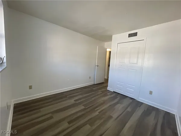 an empty room with wooden floor