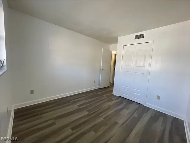 an empty room with wooden floor