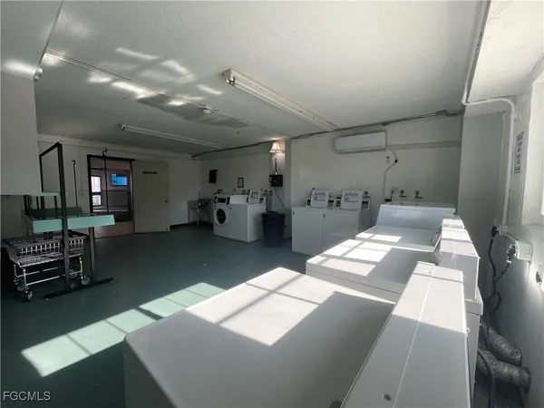 a kitchen with stainless steel appliances kitchen island granite countertop a refrigerator and a sink