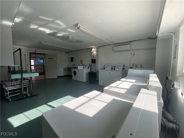 a kitchen with stainless steel appliances kitchen island granite countertop a refrigerator and a sink