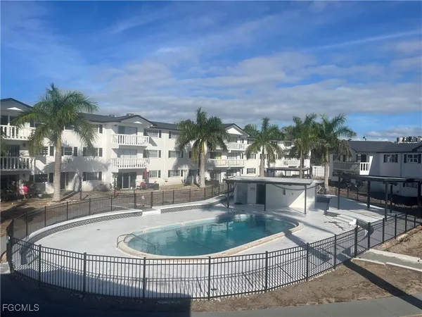 a view of a swimming pool with outdoor seating