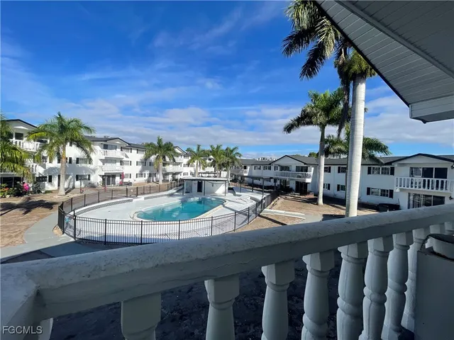 a view of a swimming pool with outdoor seating and plants