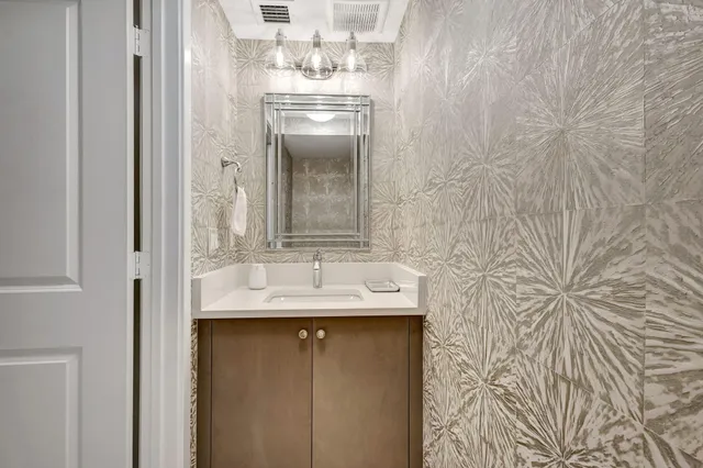 a bathroom with a granite countertop sink a toilet and shower