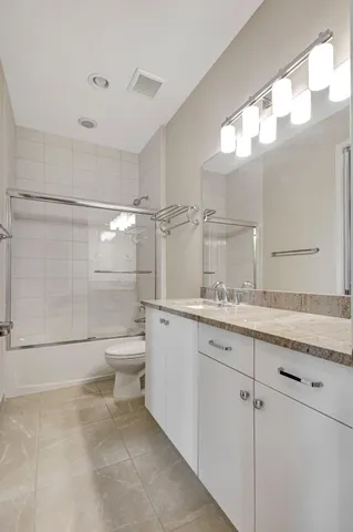 a bathroom with a sink a large mirror and a shower