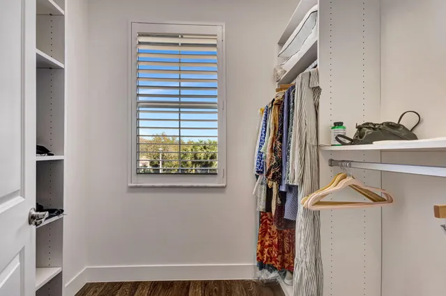 a view of a house with brick walls and a yard with plants