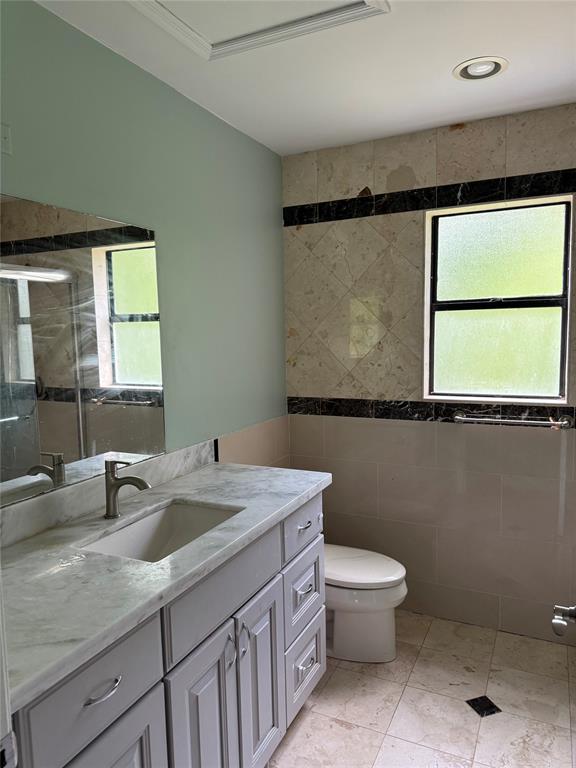 22251 Sands Point Drive Boca Raton, FL 33433 - Photo 19 of 41 a bathroom with a granite countertop sink a toilet and a mirror