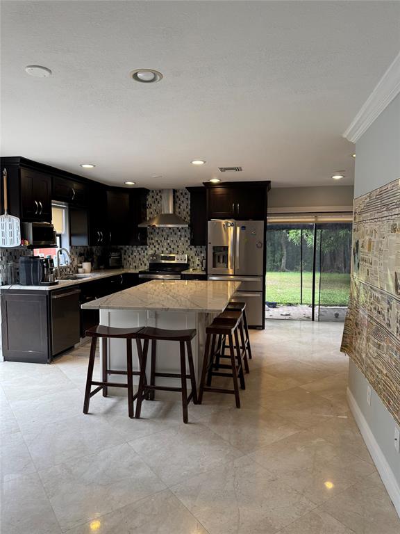 22251 Sands Point Drive Boca Raton, FL 33433 - Photo 34 of 41 a kitchen with stainless steel appliances dining table chairs and a refrigerator