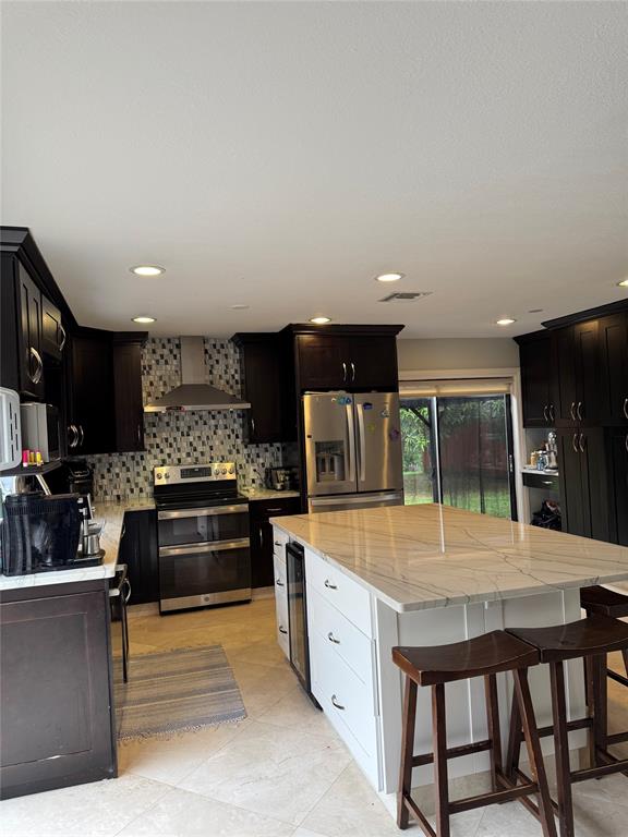 22251 Sands Point Drive Boca Raton, FL 33433 - Photo 35 of 41 a kitchen with stainless steel appliances granite countertop a stove top oven a sink and a refrigerator