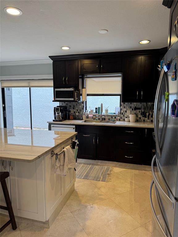 22251 Sands Point Drive Boca Raton, FL 33433 - Photo 36 of 41 a kitchen with stainless steel appliances granite countertop a sink a stove and a refrigerator