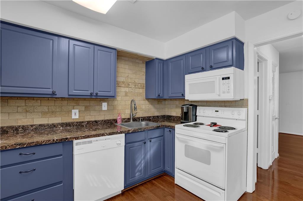 3133 Buford Highway Northeast, Unit 3 Brookhaven, GA 30329 - Photo 11 of 36 a kitchen with granite countertop cabinets and white appliances