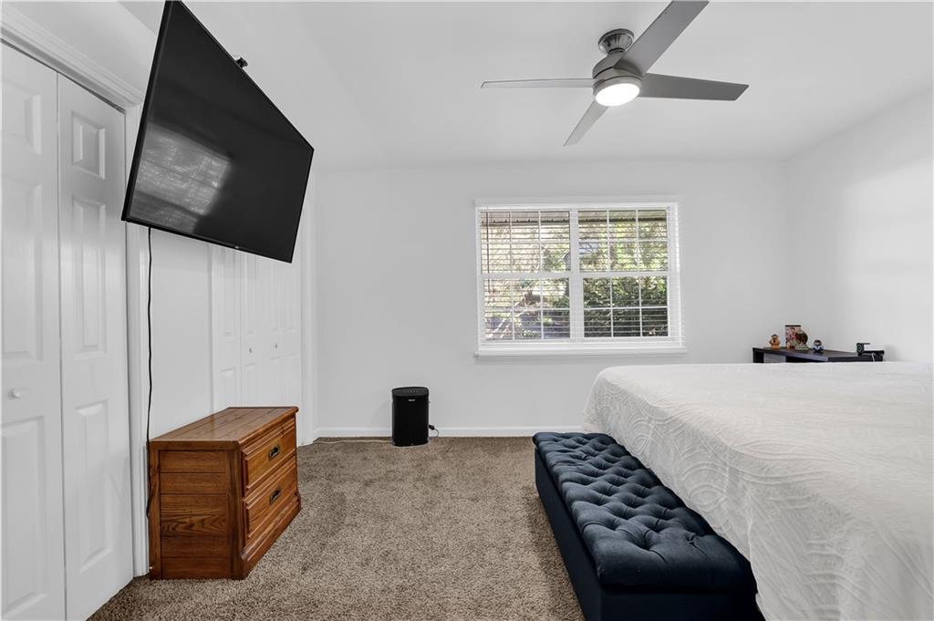 3133 Buford Highway Northeast, Unit 3 Brookhaven, GA 30329 - Photo 19 of 36 a bedroom with a bed and a flat screen tv