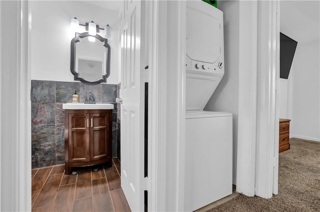 3133 Buford Highway Northeast, Unit 3 Brookhaven, GA 30329 - Photo 23 of 36 a bathroom with a sink a mirror and a toilet