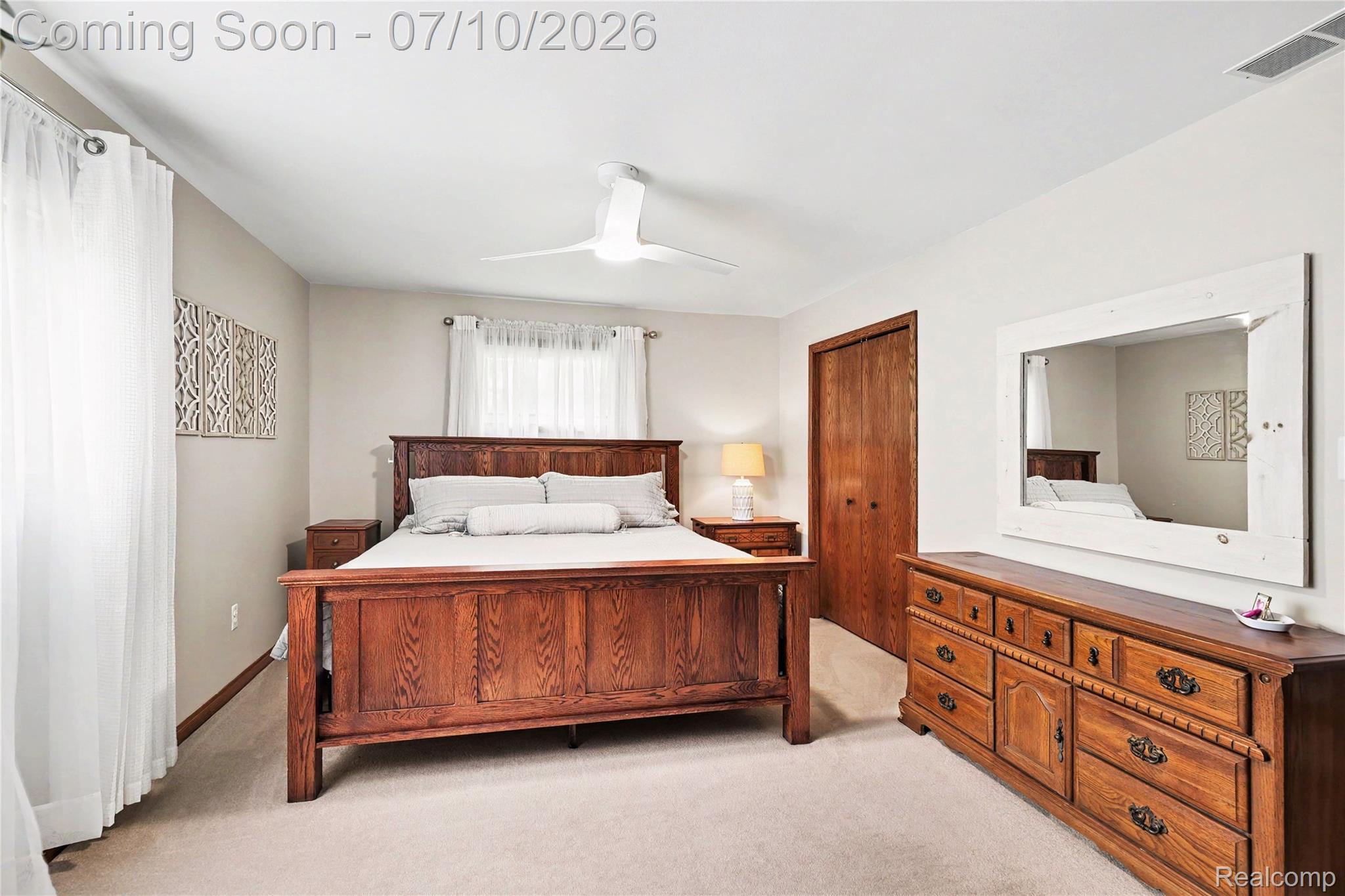 2180 Hurst Road St. Clair, MI 48079 - Photo 24 of 39 Carpeted bedroom with a modern ceiling fan, wood-finish bi-fold closet doors, and light-toned walls