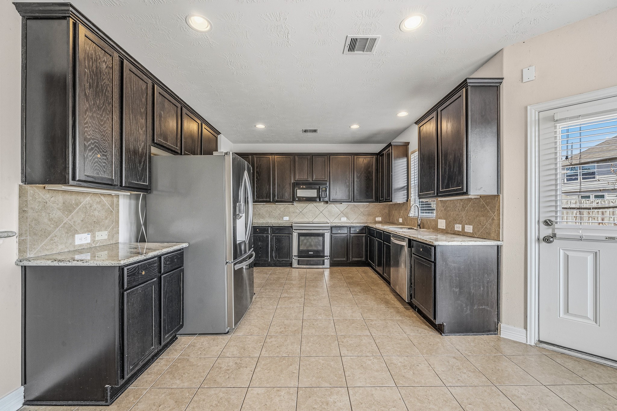 22922 Jetty Manor Lane Spring, TX 77373 - Photo 11 of 46 a large kitchen with stainless steel appliances lots of counter top space
