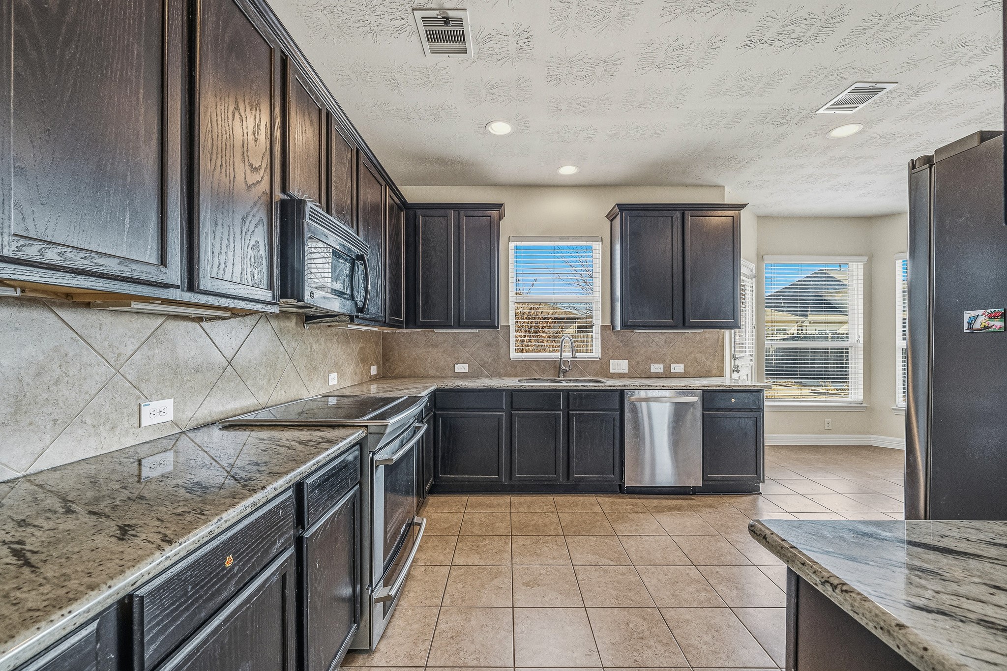 22922 Jetty Manor Lane Spring, TX 77373 - Photo 12 of 46 a kitchen with a sink stove top oven and cabinets
