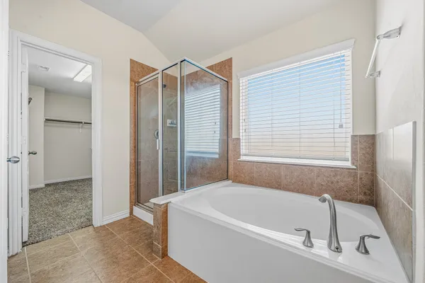 a bathroom with a bathtub and a shower