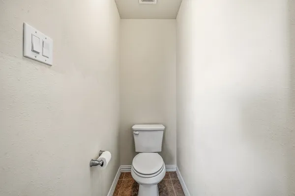 a white toilet sitting next to a small bathroom