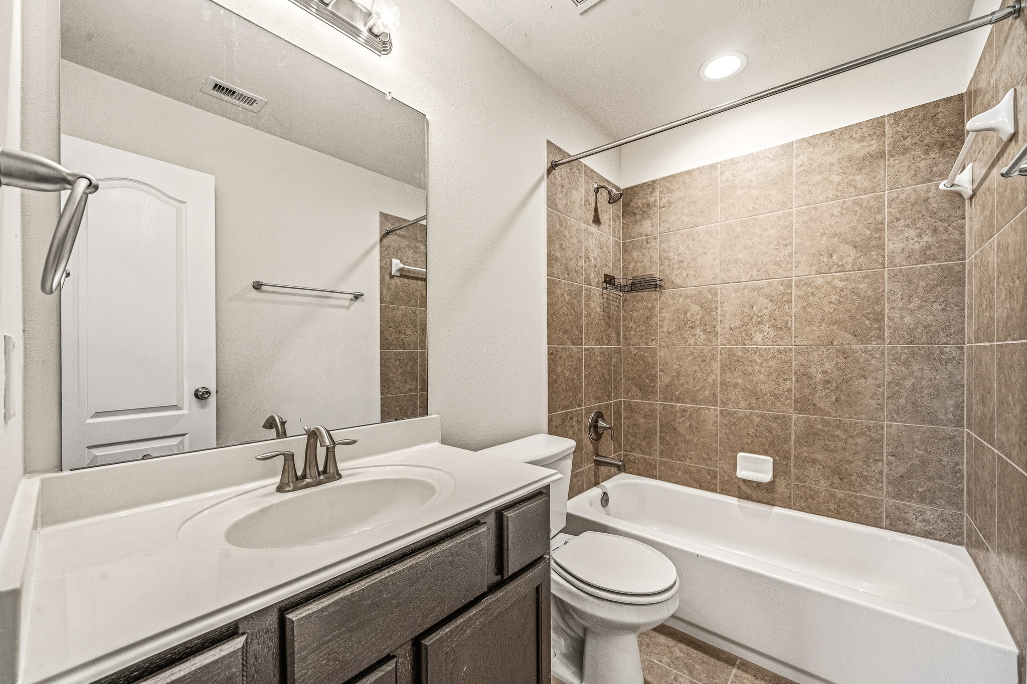 22922 Jetty Manor Lane Spring, TX 77373 - Photo 28 of 46 a bathroom with a sink a toilet and a bathtub