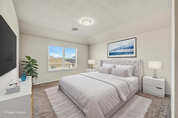 a bedroom with a large bed and a large window