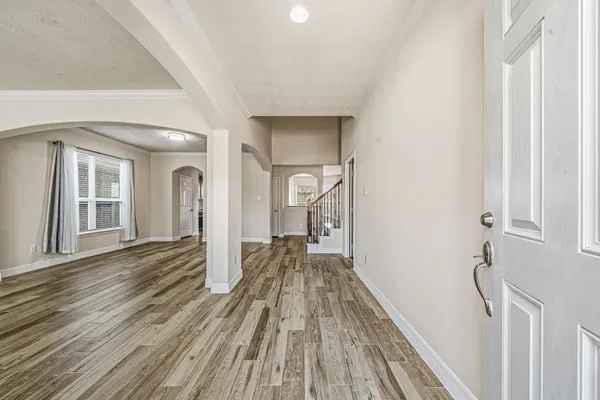 a view of a room with wooden floor