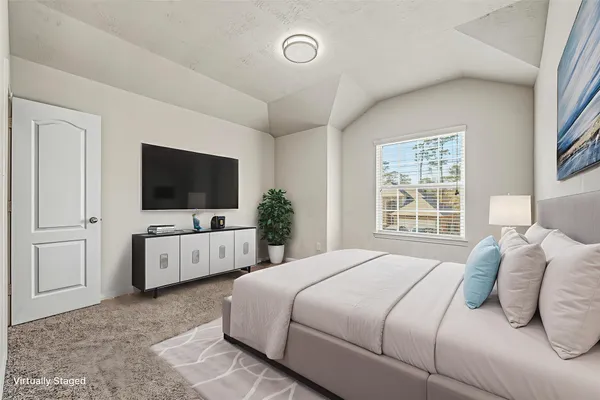 a bedroom with a flat screen television and a bed