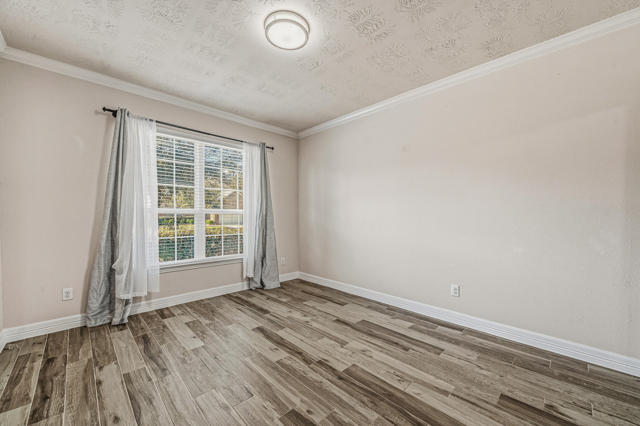 22922 Jetty Manor Lane Spring, TX 77373 - Photo 4 of 46 an empty room with wooden floor and windows