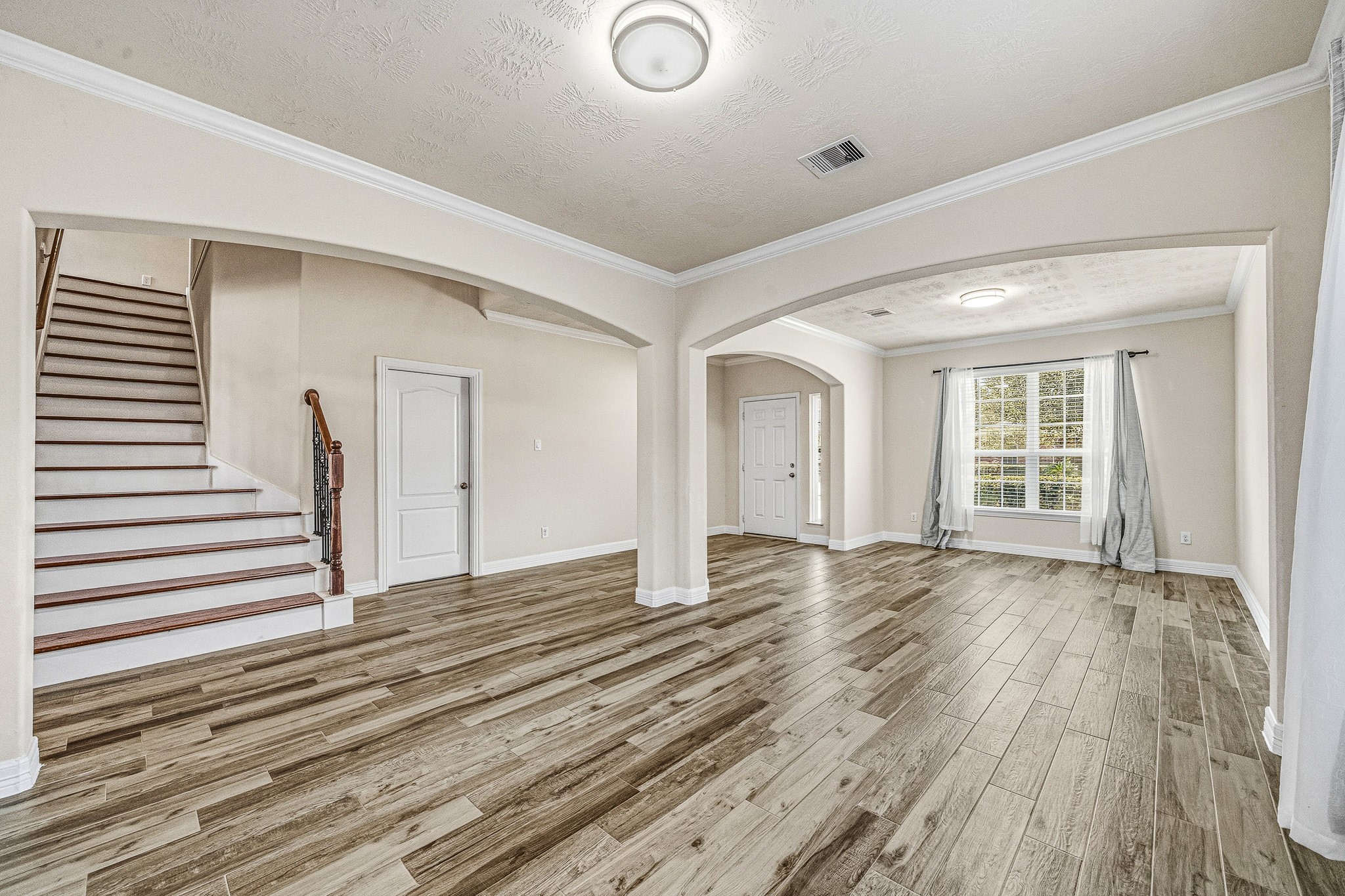 22922 Jetty Manor Lane Spring, TX 77373 - Photo 9 of 46 a view of a livingroom with wooden floor and stairs