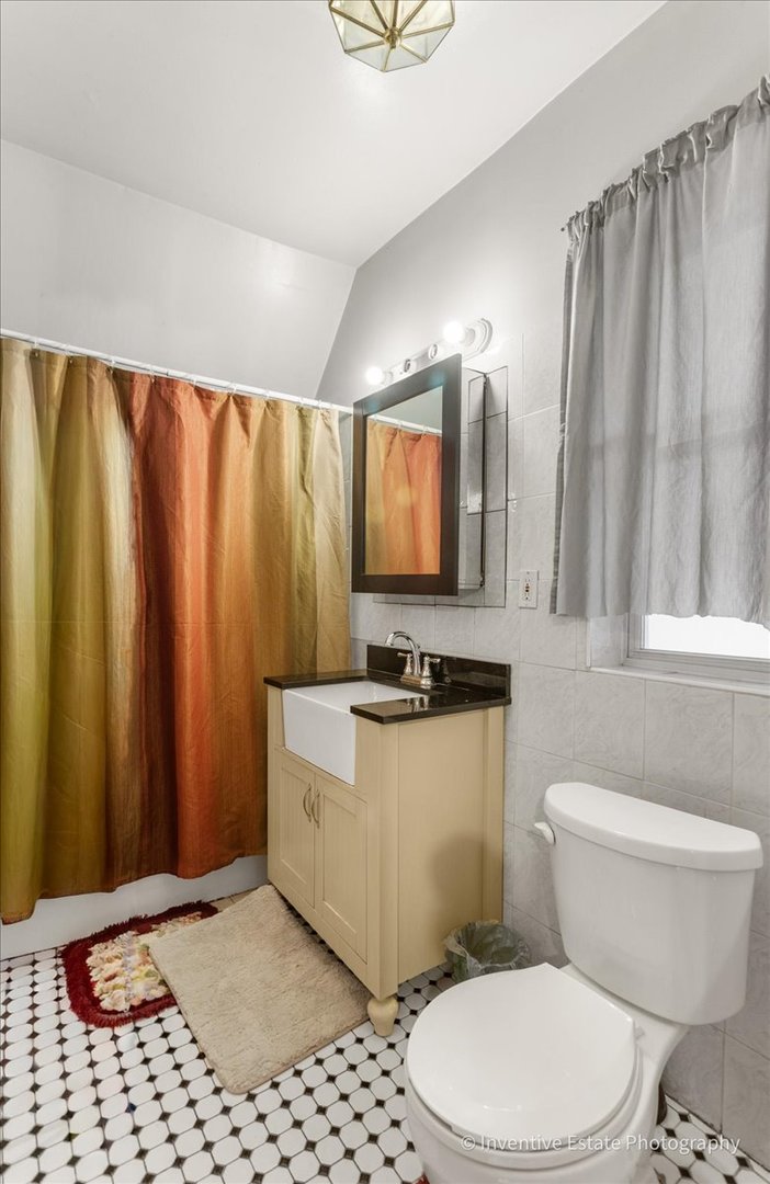 12018 South Loomis Street Chicago, IL 60643 - Photo 12 of 21 a bathroom with a sink a toilet a mirror and shower curtain