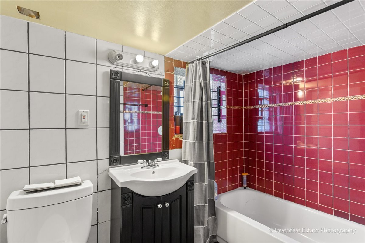 12018 South Loomis Street Chicago, IL 60643 - Photo 13 of 21 a bathroom with a sink a toilet and shower
