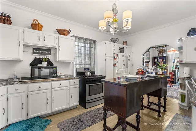 a kitchen with cabinets a sink and stainless steel appliances