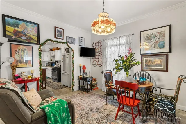 a view of a dining room with furniture and a chandelier