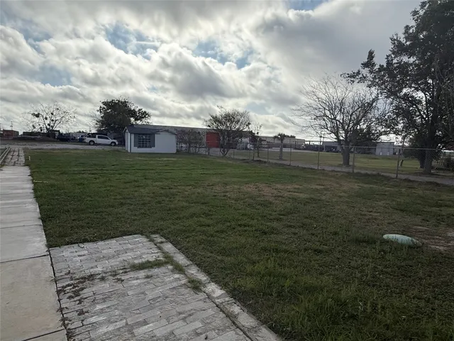 a view of a big yard next to a lake