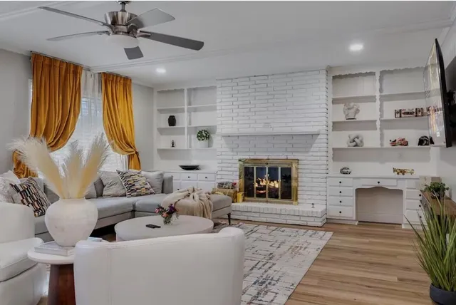 a living room with furniture fireplace and flat screen tv