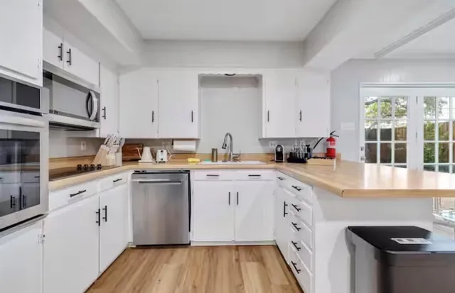 a view of kitchen with cabinets and wooden floor